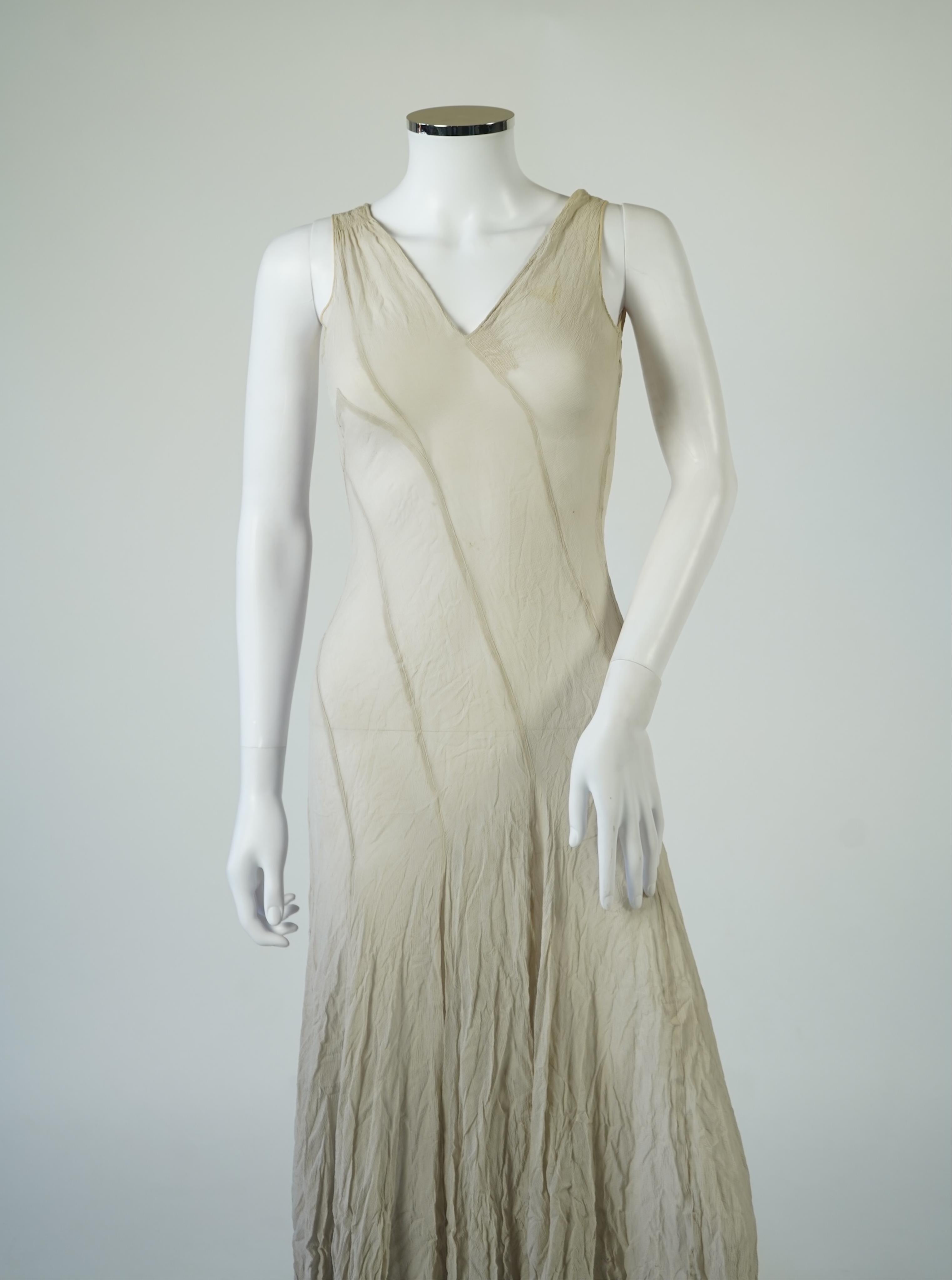 A 1930's grey chiffon bias cut ladies evening dress. 120cm long. Condition - has a small hole at the back and a light mark possibly removed with washing.
